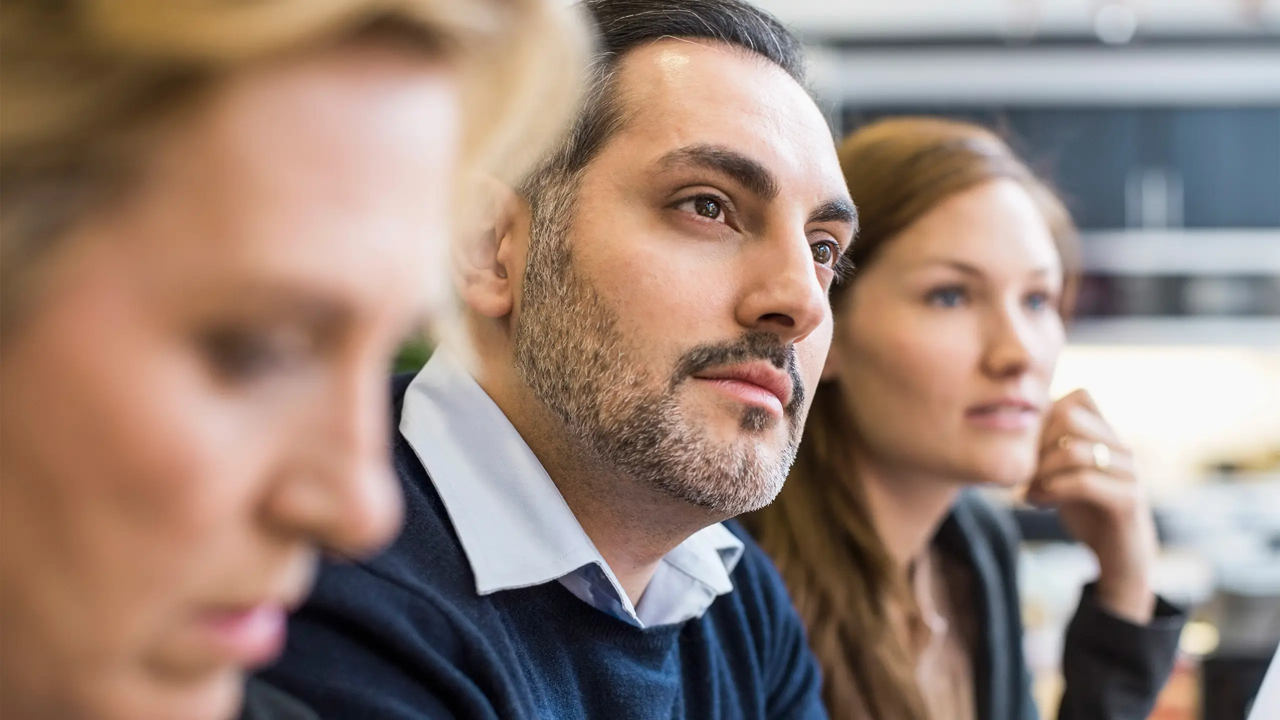 Concentrating businessman looking away in an office meeting