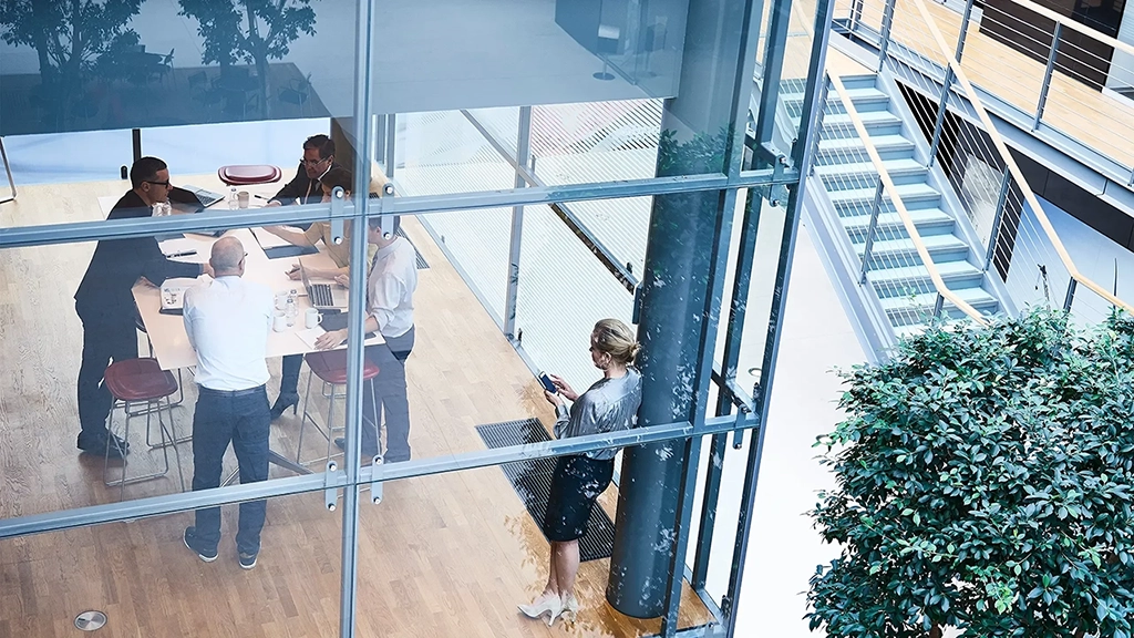 High-angle view of businessmen and businesswomen meeting in a conference room High-angle view of businessmen and businesswomen meeting in a conference room