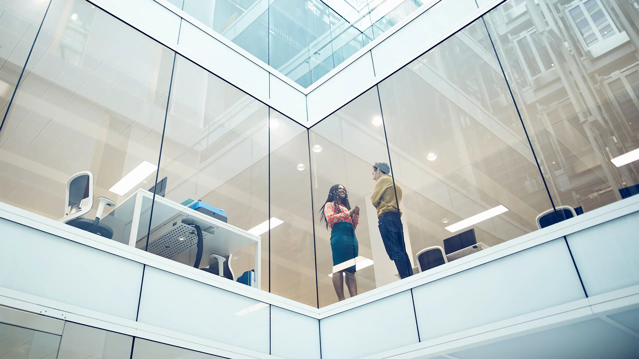 Work colleagues talking in a modern office setting