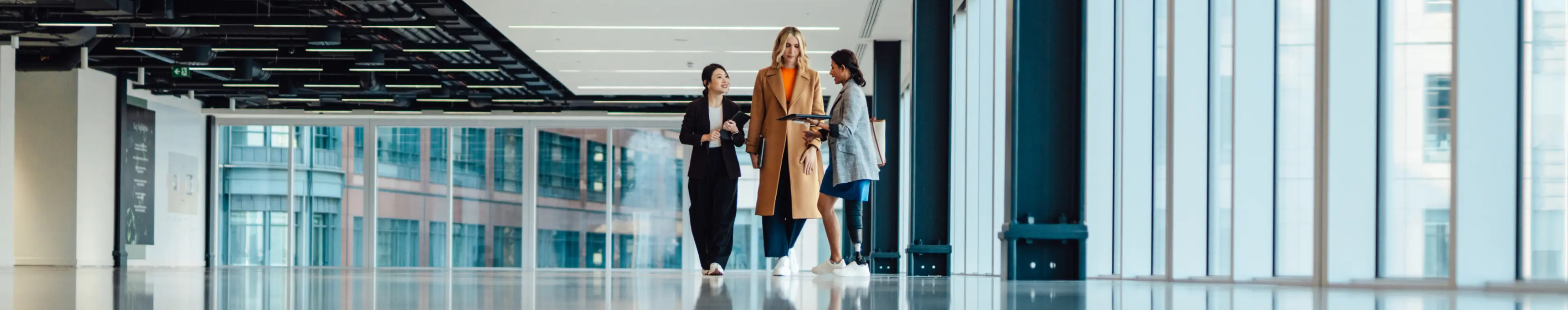 Mixed group of businesswomen viewing new office space with an estate agent Mixed group of businesswomen viewing new office space with an estate agent