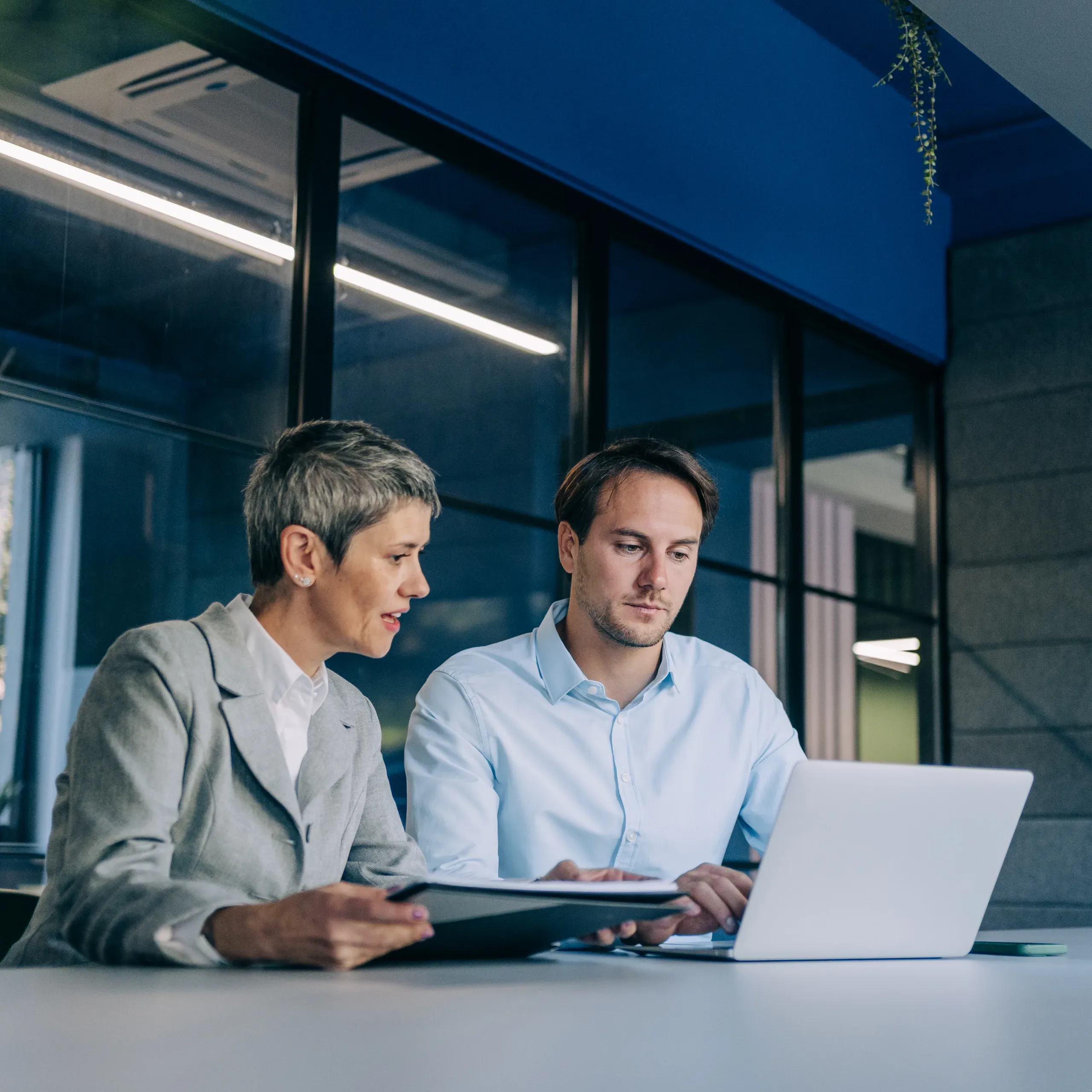 Colleagues discussing a project in their workplace