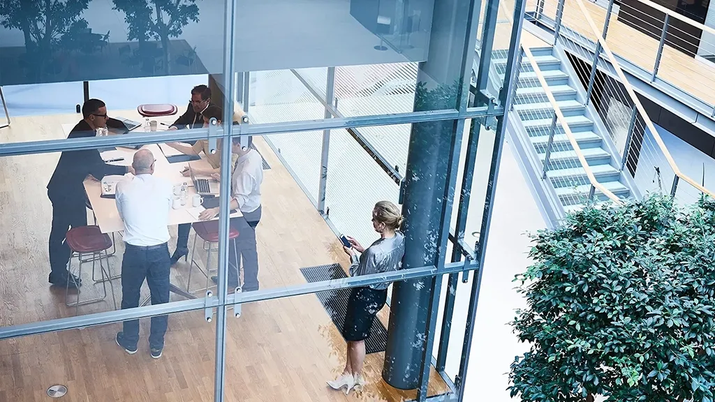 High-angle view of businessmen and businesswomen meeting in a conference room