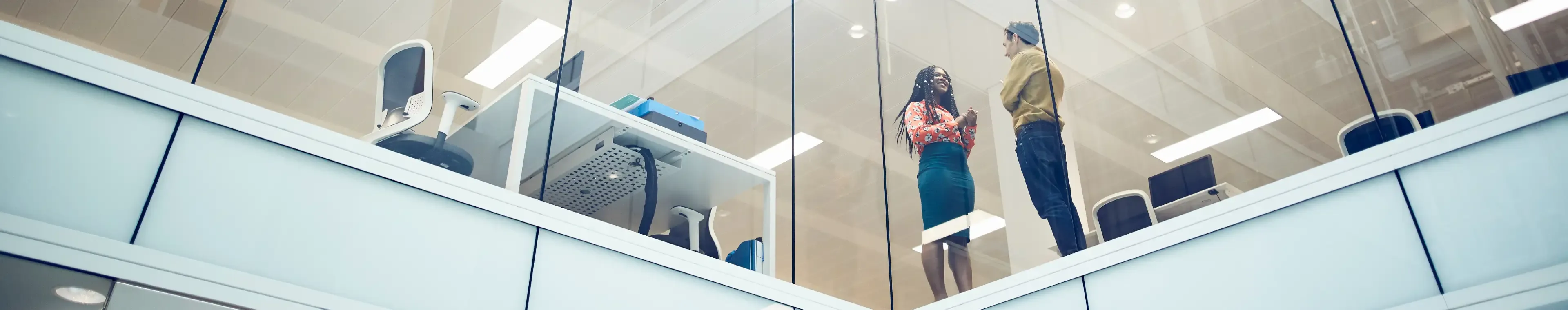 Work colleagues talking in a modern office setting